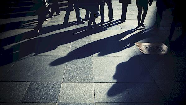 Shadows of People on a Busy Sidewalk